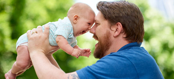 Dad and baby share a laugh.